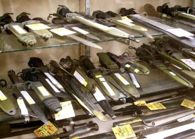 Shelves filled with bayonets and knives.