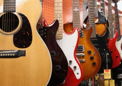 A variety of guitars in multiple colors.